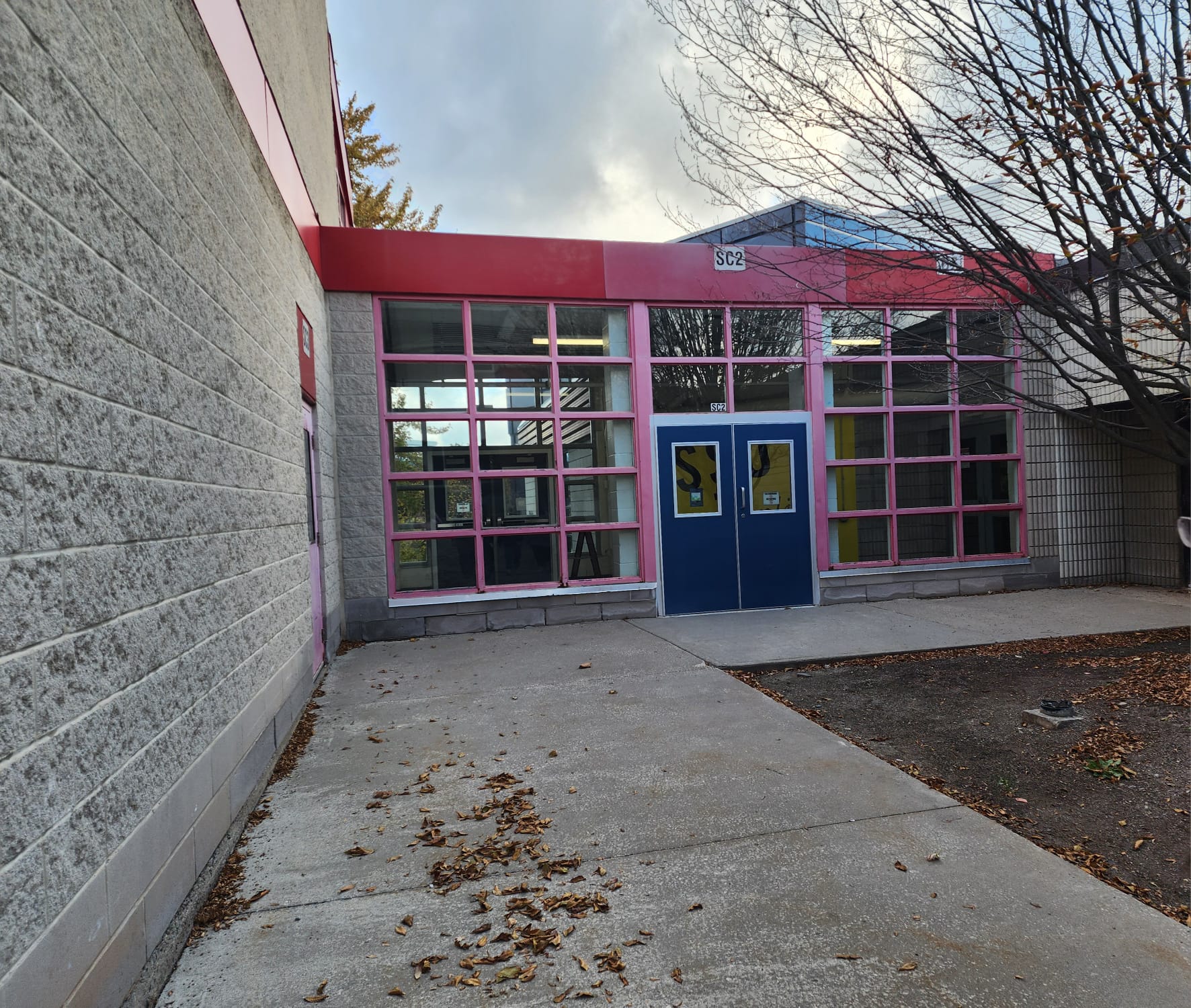 When entering the Marquee through the side door it is very empty and cold design wise. The concrete gives texture and the windows have pink borders. The door is blue which creates contrast between the pinks and greys in the area. 